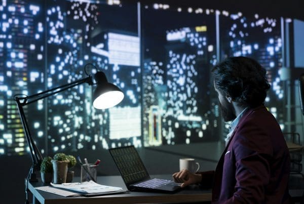 Private equity manager analyzing financial reports at night